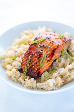 A white bowl containing miso salmon over ginger rice.