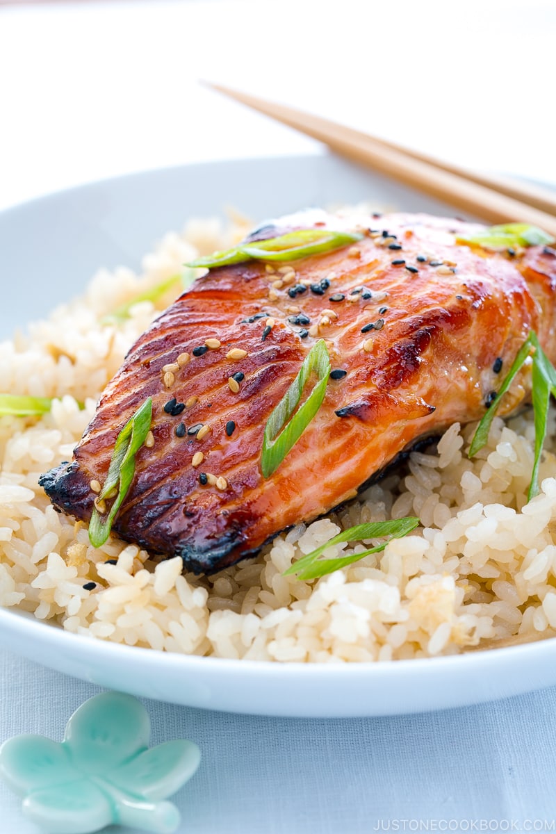 A white bowl containing miso salmon over ginger rice.