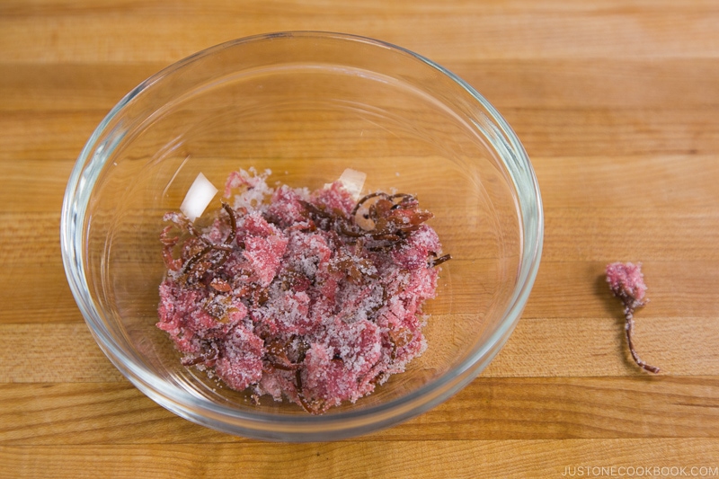 Edible Salt Pickled Cherry Blossoms in a glass bowl.