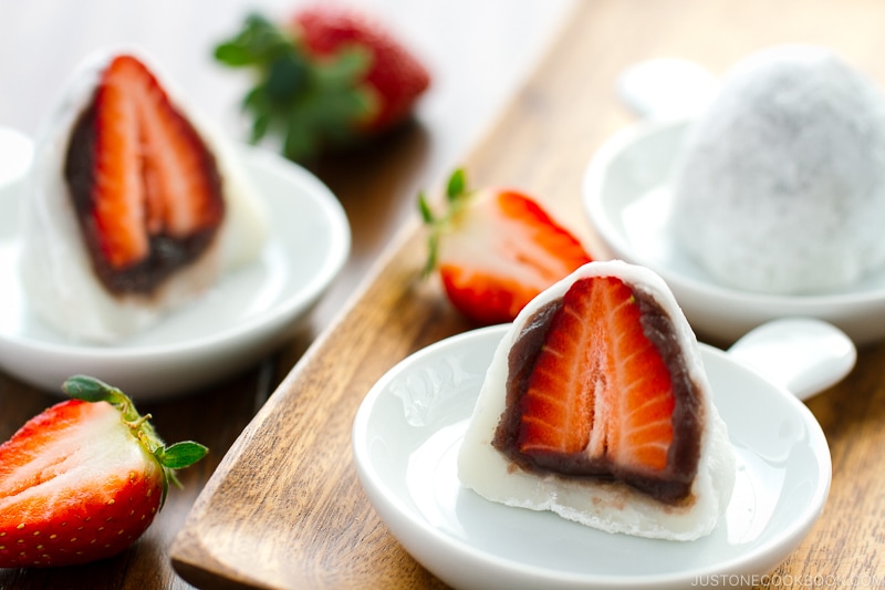 Sliced-in-half Strawberry Mochi (Ichigo Daifuku) on a white plate.