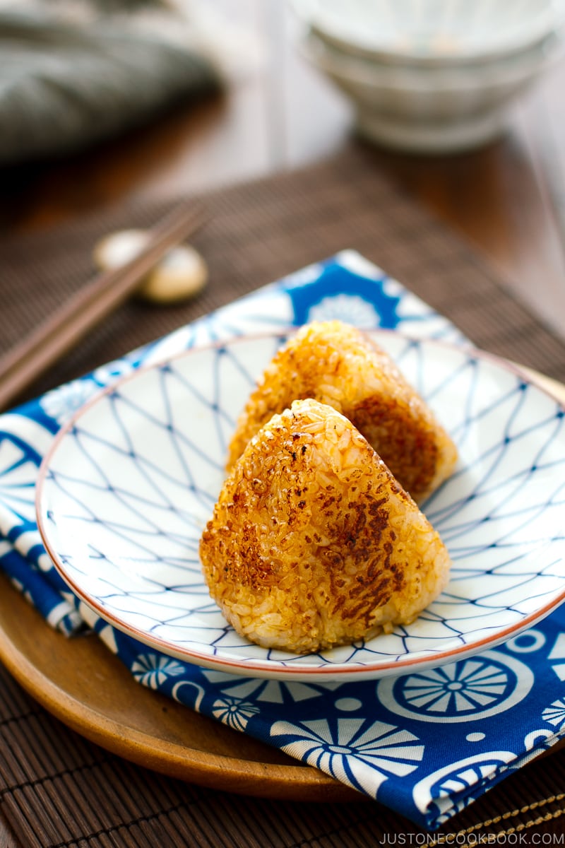 A Japanese blue and white plate containing Yaki Onigiri - Japanese Grilled Rice Balls).