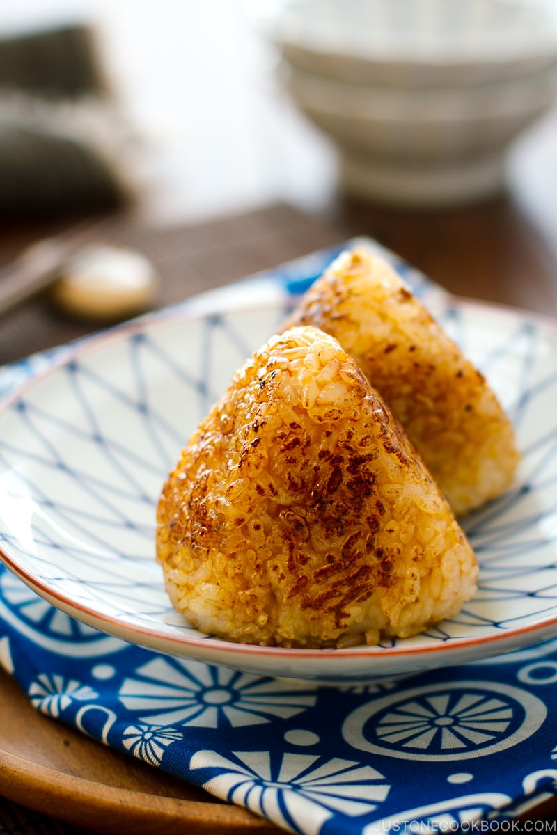 A Japanese blue and white plate containing Yaki Onigiri - Japanese Grilled Rice Balls).