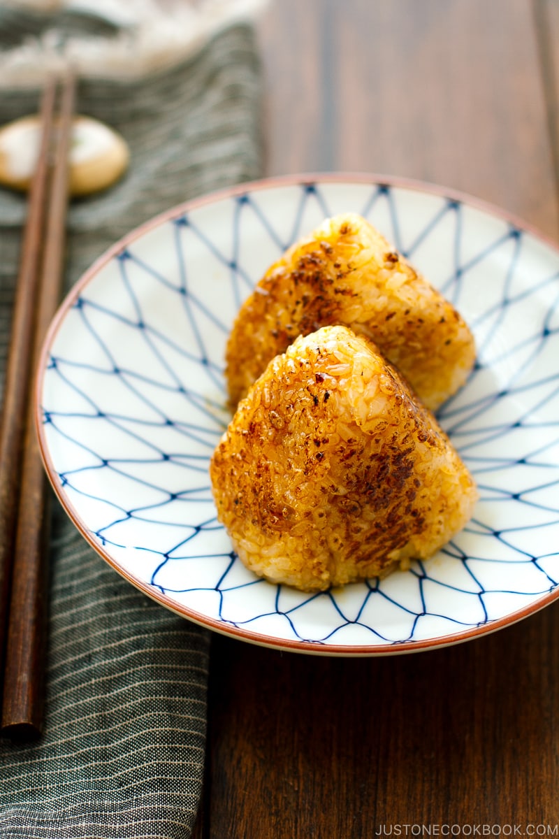 A Japanese blue and white plate containing Yaki Onigiri - Japanese Grilled Rice Balls).