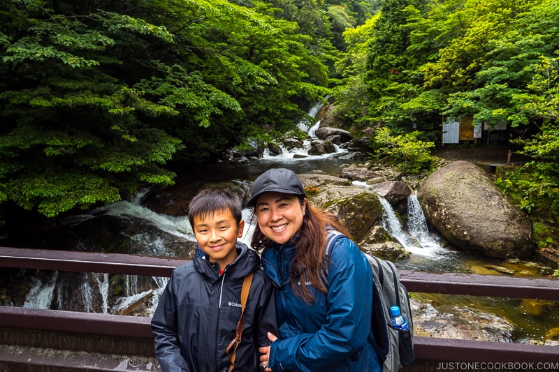 lady and son on a bridge at Shiratani Unsui Gorge - Yakushima Travel Guide | www.justonecookbook.com
