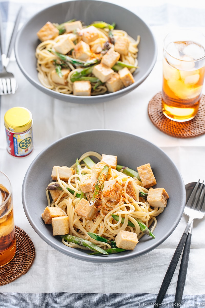 A grey bowl containing Creamy Miso Pasta with Tofu and Asparagus.