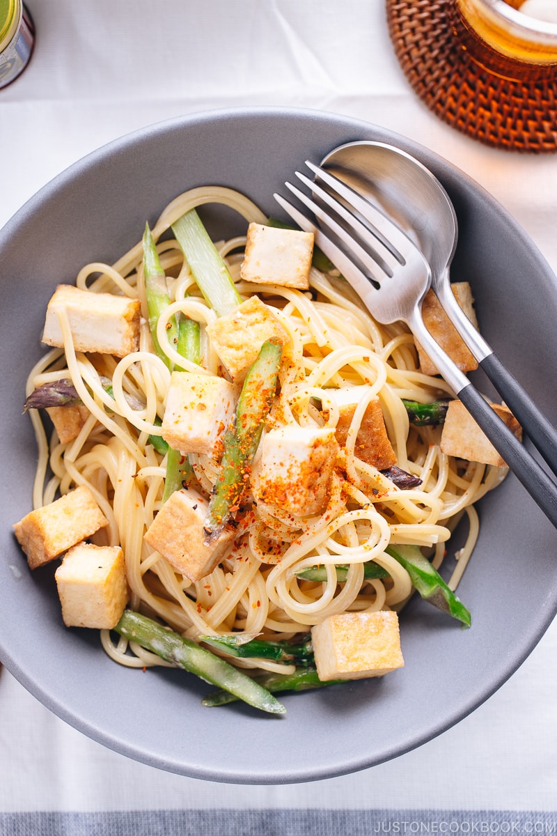 A grey bowl containing Creamy Miso Pasta with Tofu and Asparagus.