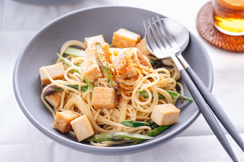 A grey bowl containing Creamy Miso Pasta with Tofu and Asparagus.