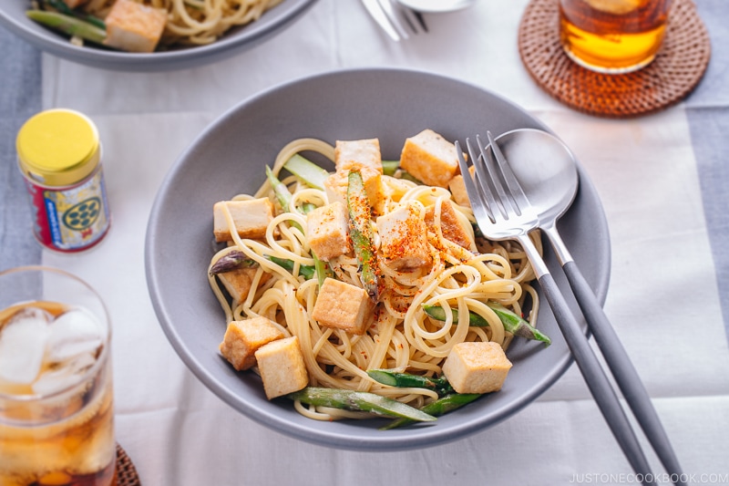 A grey bowl containing Creamy Miso Pasta with Tofu and Asparagus.