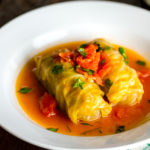 White bowl containing Japanese-style stuffed cabbage rolls.