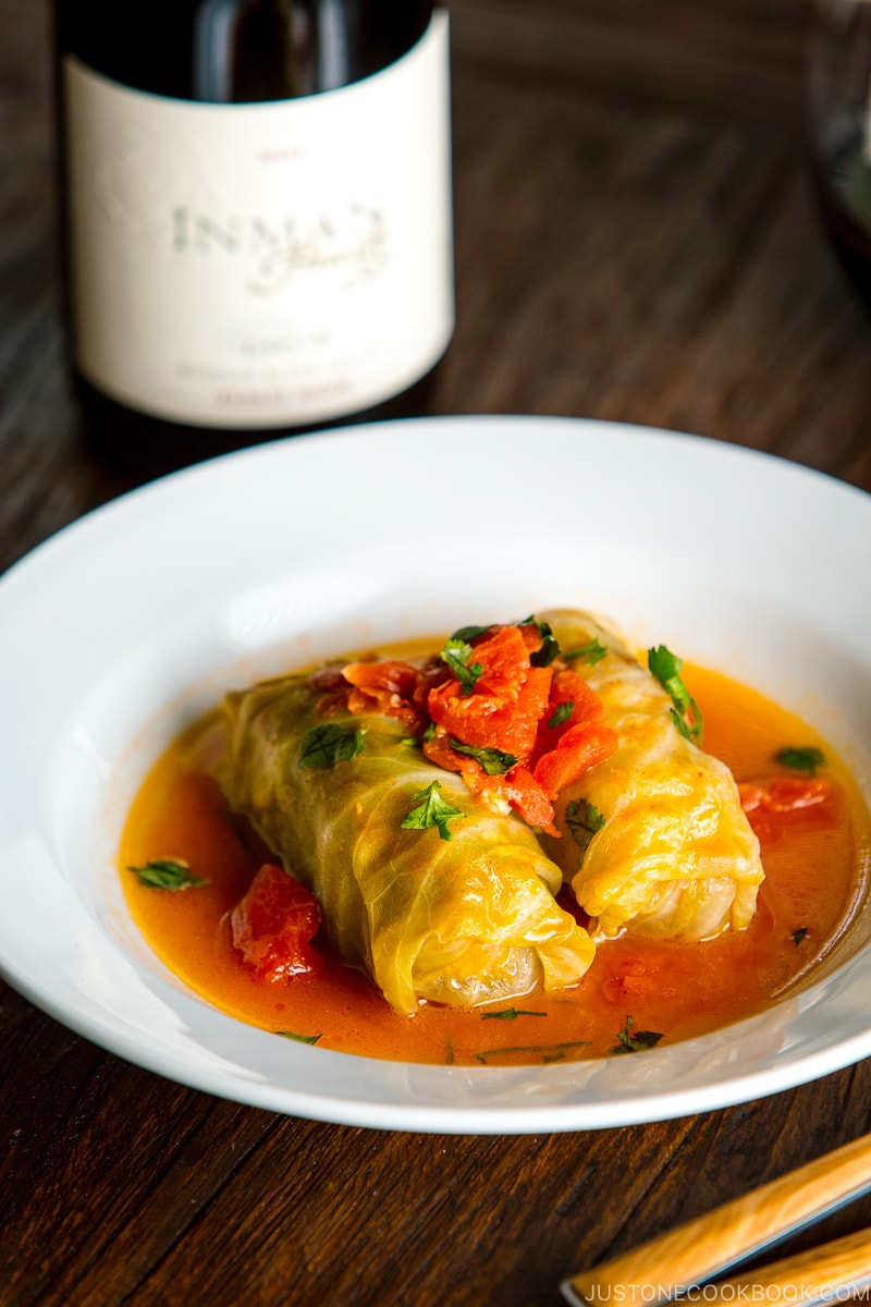 White bowl containing Japanese-style stuffed cabbage rolls.