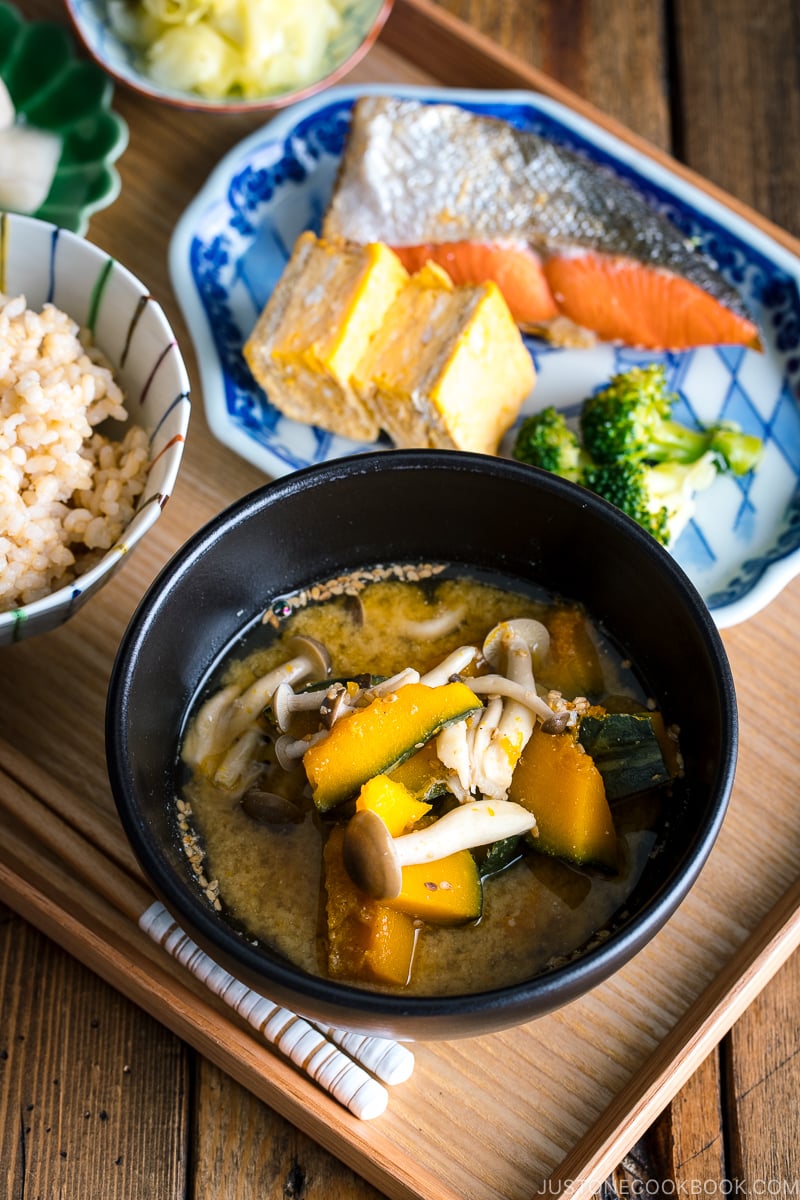 Kabocha Miso Soup served in a black bowl.