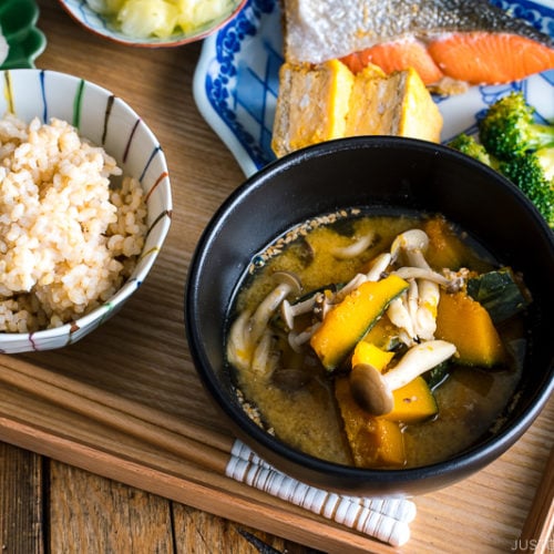 Kabocha Miso Soup served in a black bowl.