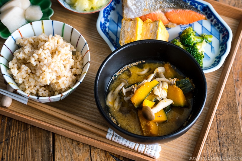 Kabocha Miso Soup served in a black bowl.