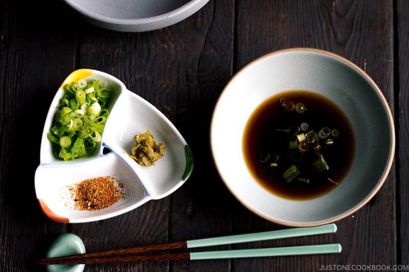 dish with soy sauce next to dish with Japanese herbs and spices