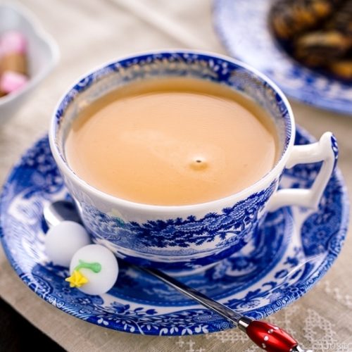 Royal milk tea in a blue and white tea cup.