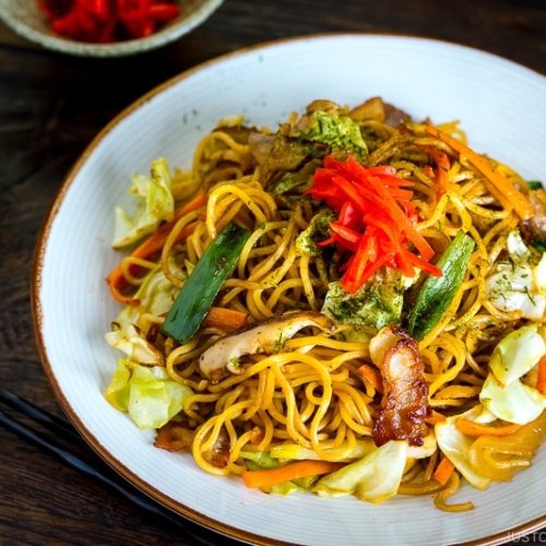 A white plate containing Yakisoba (Japanese Stir Fry Noodles).