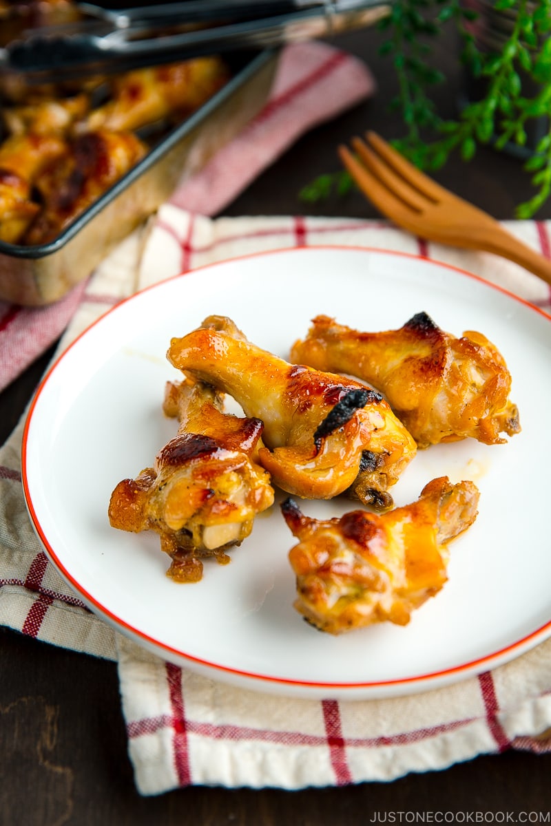 A white plate containing Honey Soy Chicken Wings