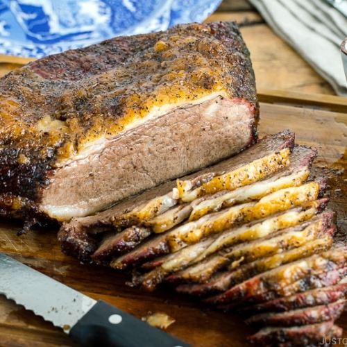 Smoked A5 Japanese wagyu brisket on a wood cutting board next to bbq sauce and potato salad | Easy Japanese Recipes at JustOneCookbook.com