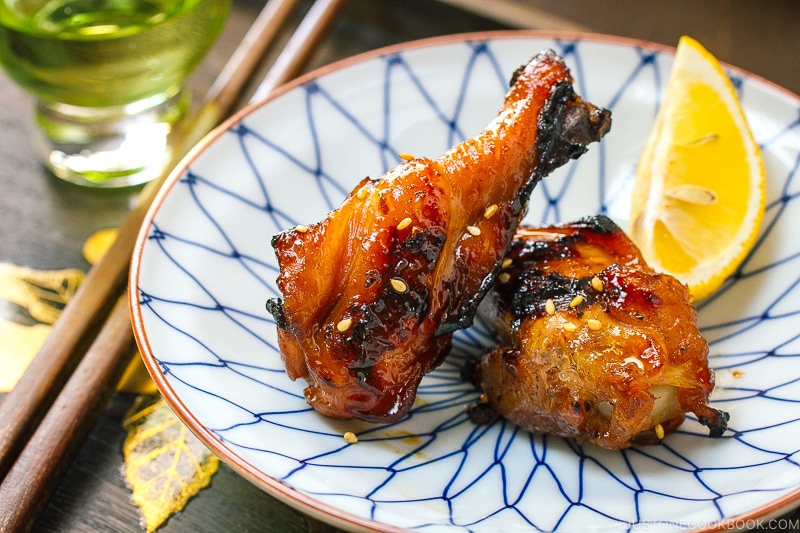 A blue and white plate containing Sweet and Spicy BBQ Chicken Wings.