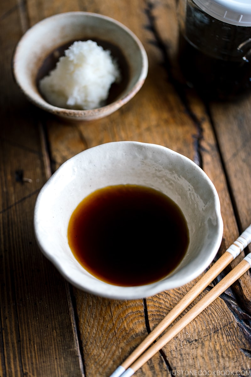 A white bowl containing Tempura Dipping Sauce (Tentsuyu) served with grated daikon.