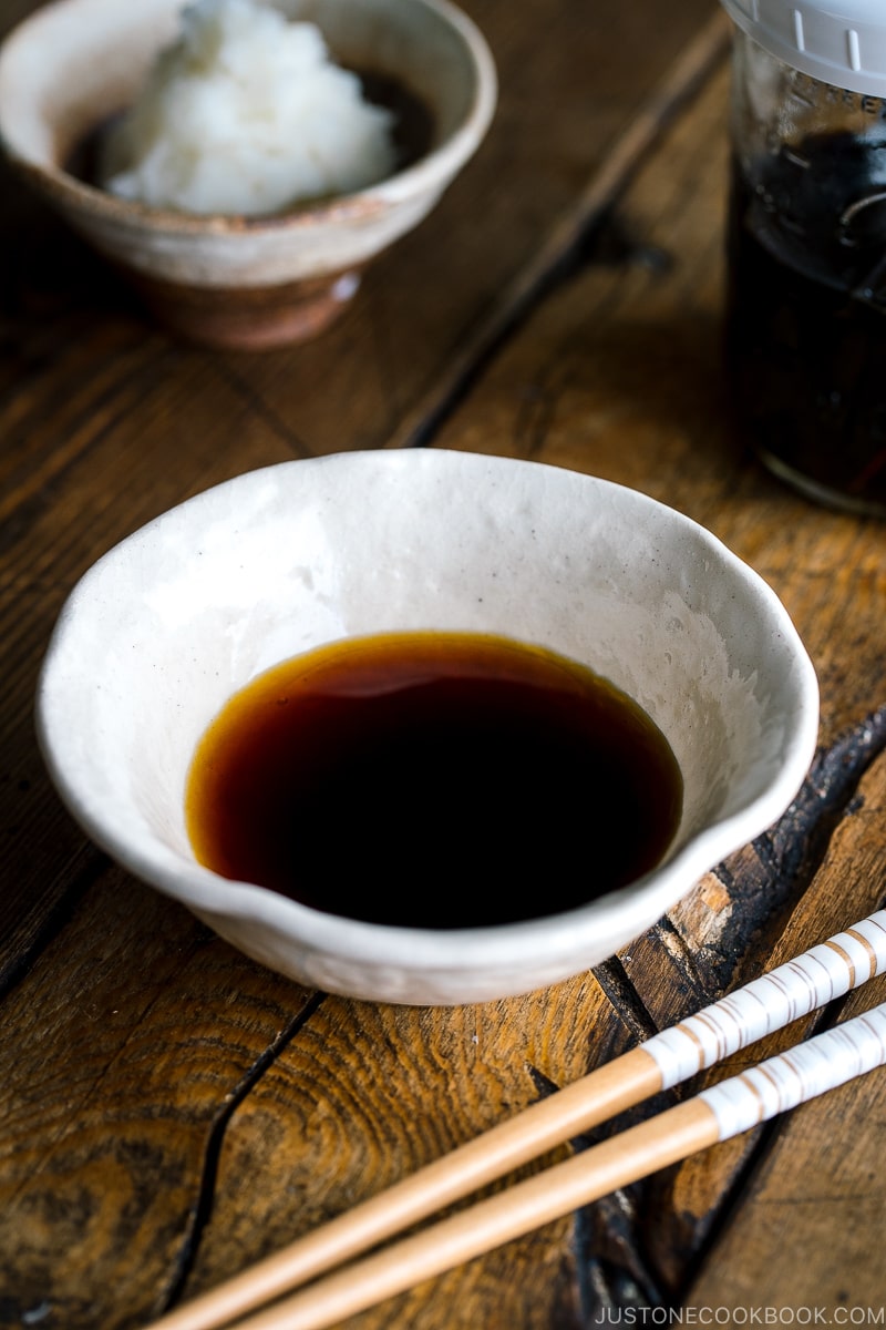 A white bowl containing Tempura Dipping Sauce (Tentsuyu) served with grated daikon.