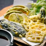 A basket containing assorted vegetable tempura.