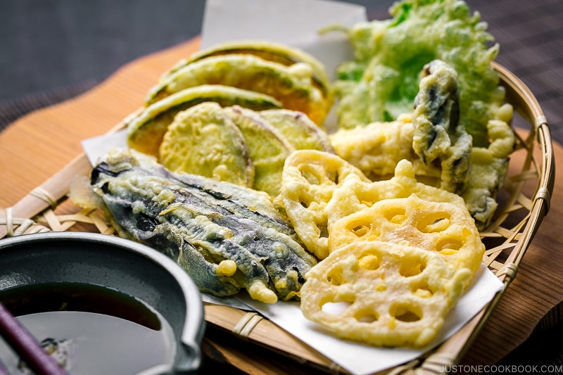 A basket containing assorted vegetable tempura.