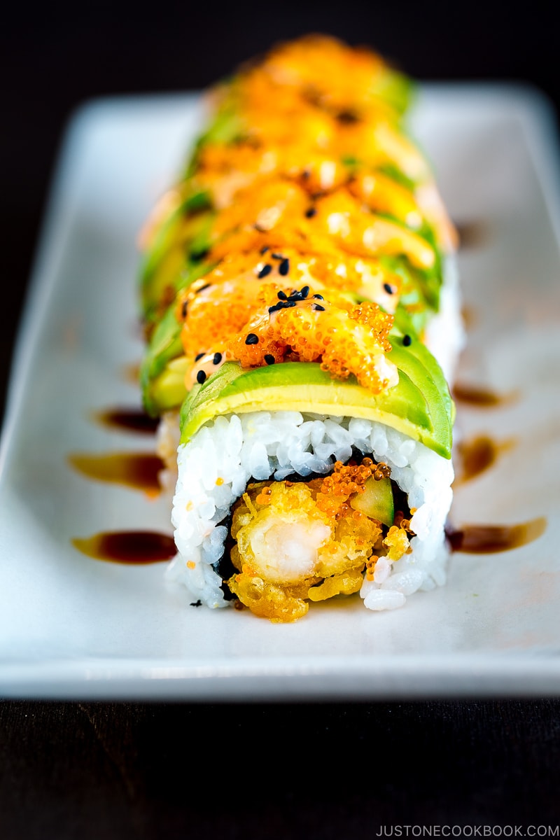 A white plate containing a Dragon Roll.