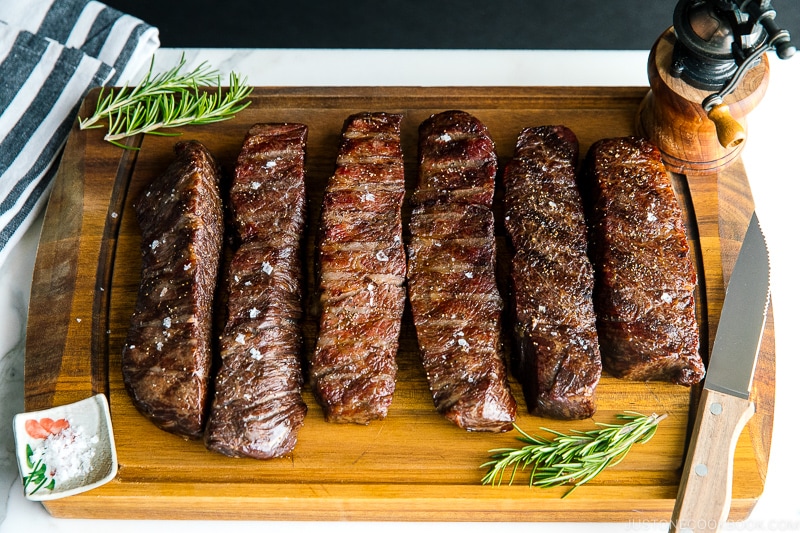 steaks reverse seared to medium rare, medium, and medium well on Traeger on top of wood cutting board