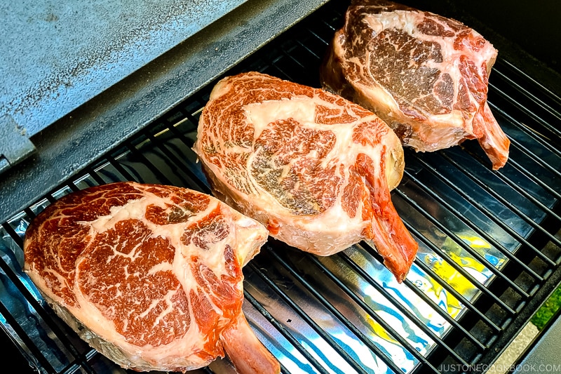 Steak cooking on a smoker