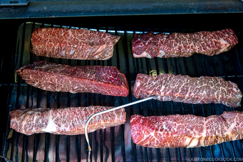 steak in Traeger with meat thermometer inserted