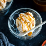 A glass bowl containing Soy Sauce Caramel Ice Cream topped with a drizzle of extra caramel.