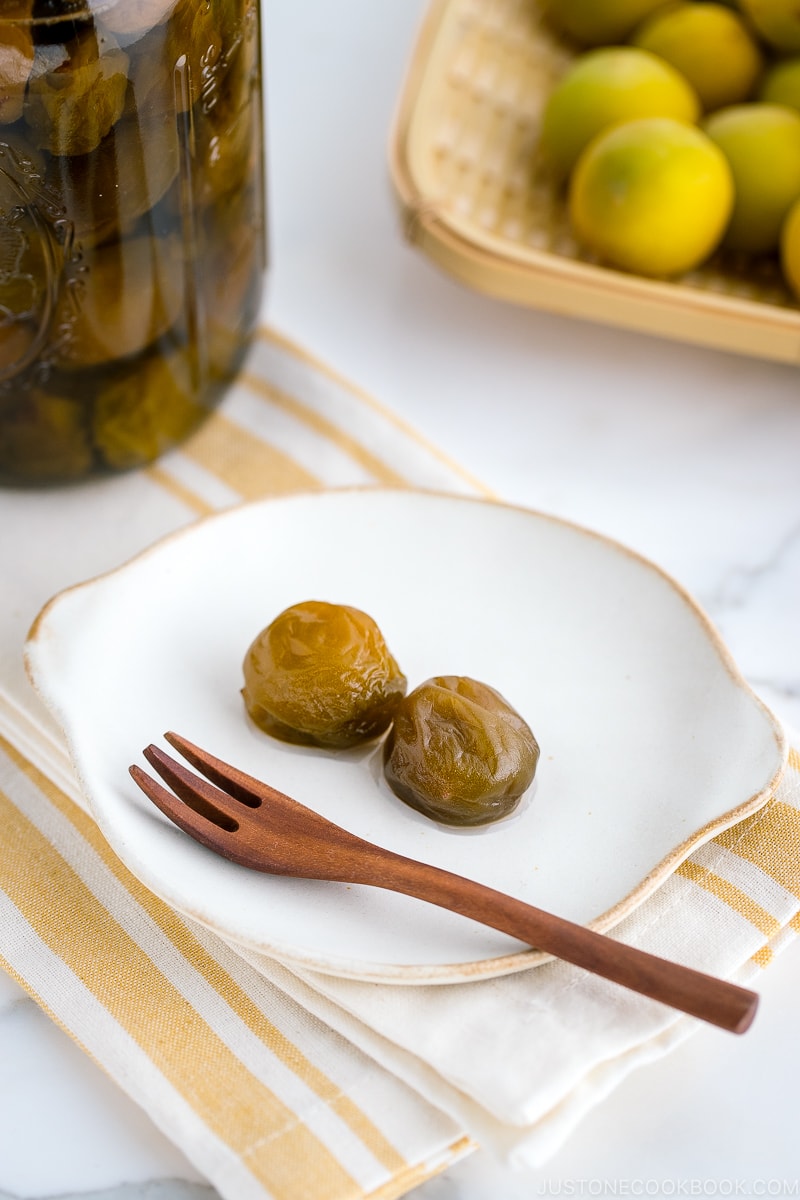 A white plate containing ume plum compote.