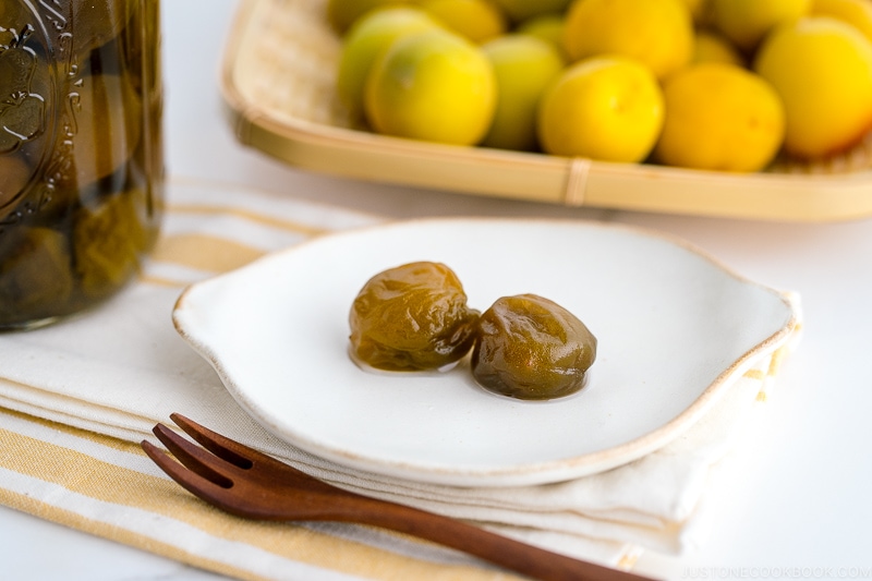 A white plate containing ume plum compote.