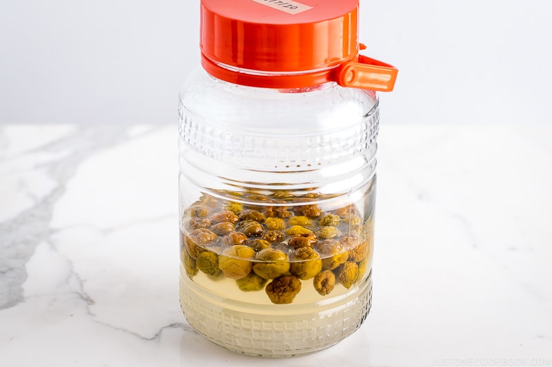 A glass container containing ume plum syrup.