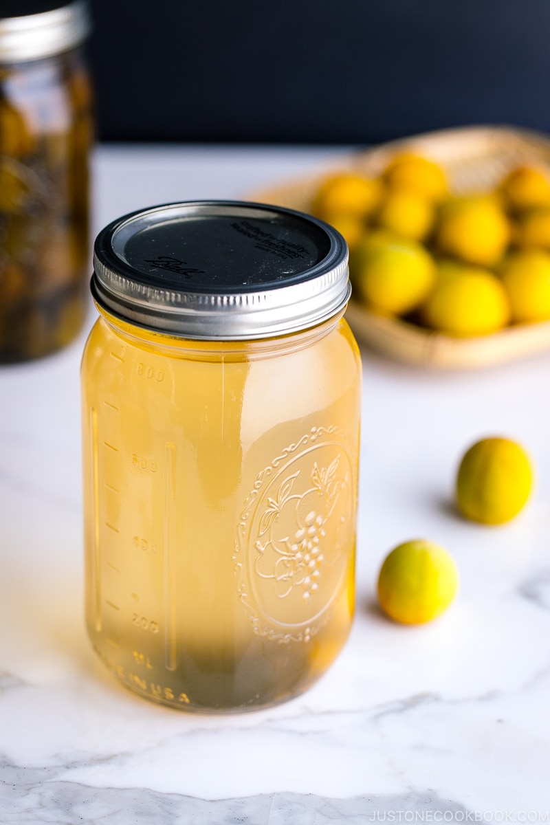 A mason jar containing ume plum syrup.