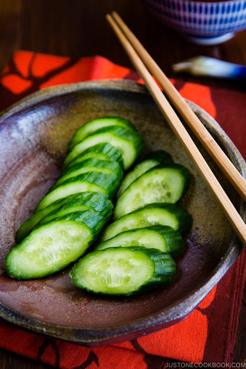 A red lacquer bowl containing Pickled Cucumber.