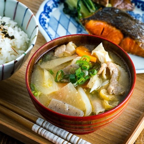 Tonjiru (Pork and Vegetable Soup) served with grilled salmon, steamed rice, and vegetable side dishes.