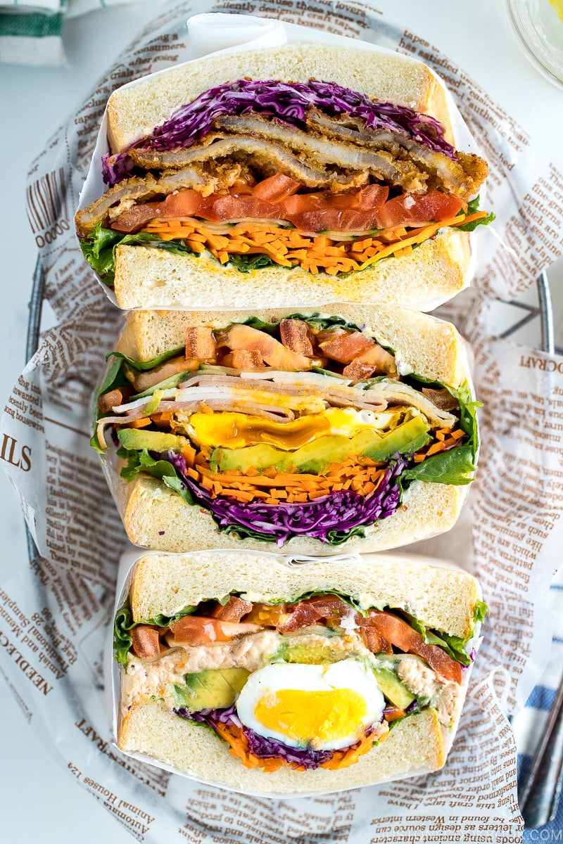 Colorful thick Japanese sandwich, Wanpaku Sandiwch (Sando), shows the filling and piles up on the table.