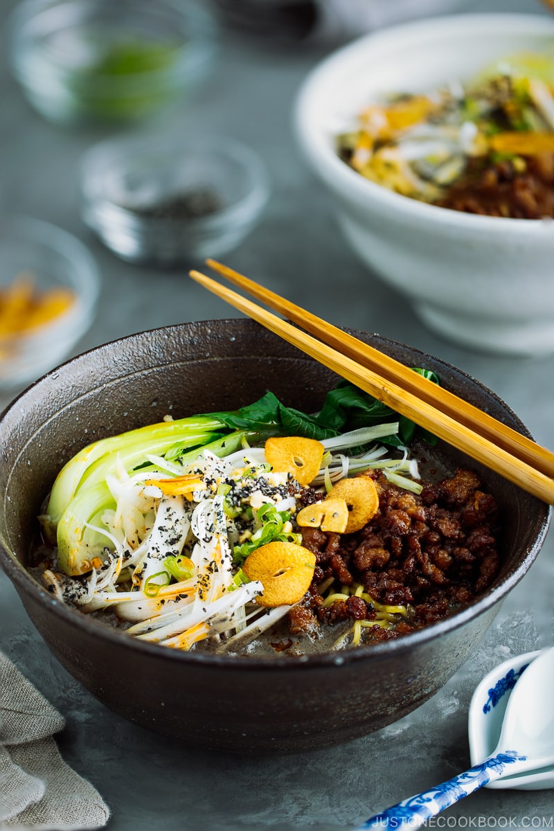 A black bowl containing Black Sesame Dan Dan Noodles.