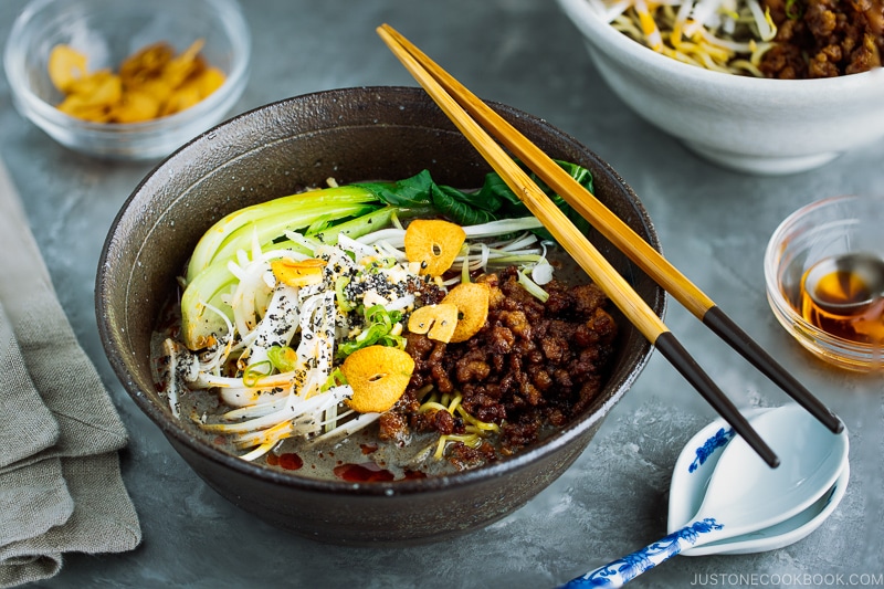 A black bowl containing Black Sesame Dan Dan Noodles.