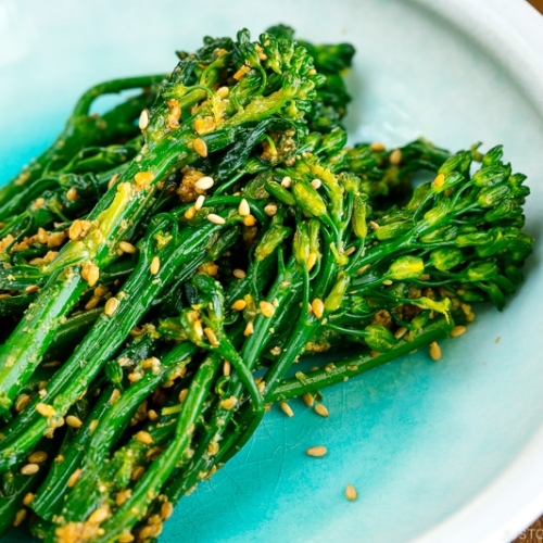 A white bowl containing Broccolini Gomaae.