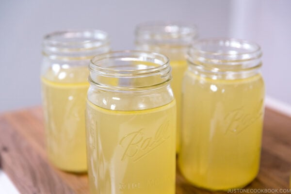 Mason jars containing Homemade Chicken Stock.