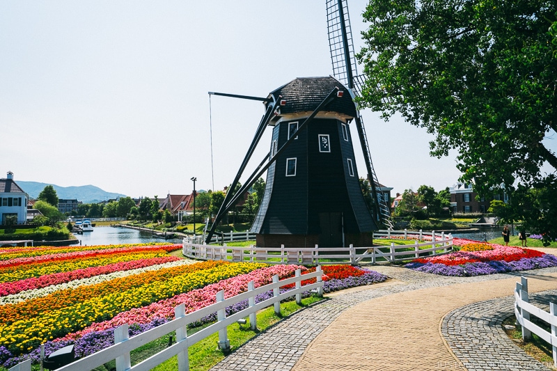 windmill next to flower bed