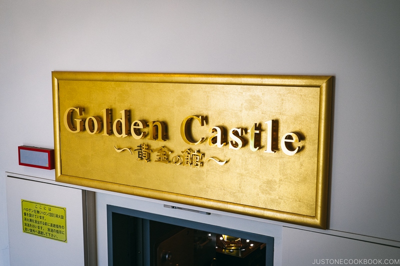 gold sign that says golden castle