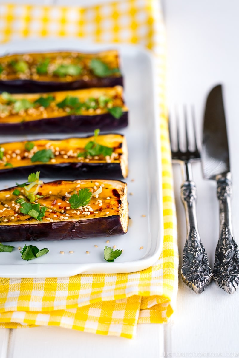 A white plate containing Miso Glazed Eggplant.