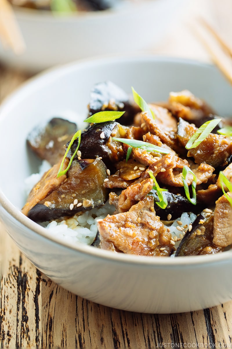 A bowl containing Miso Pork and Eggplant Stir-Fry over steamed rice.