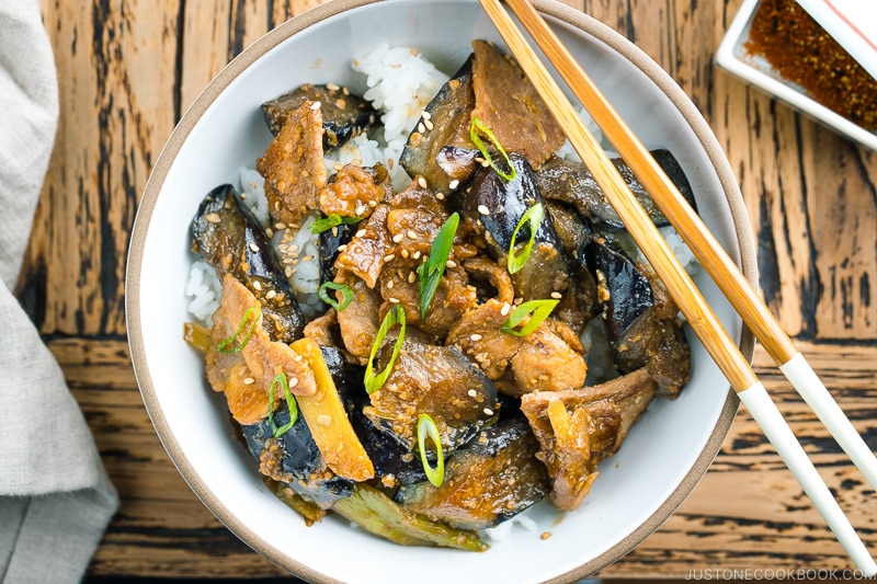 A bowl containing Miso Pork and Eggplant Stir-Fry over steamed rice.