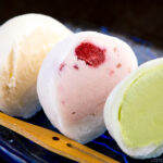 Vanilla, strawberry, and matcha mochi ice cream served on a glass plate.