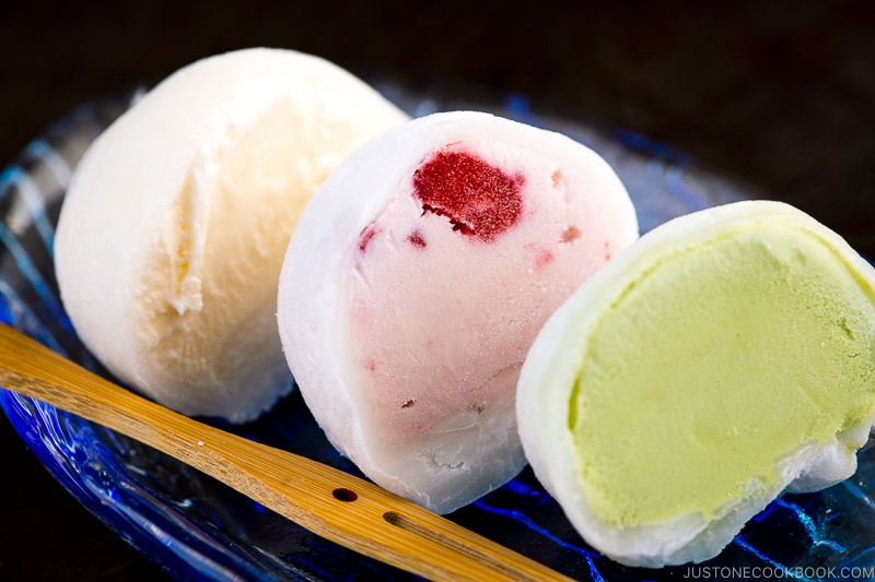 Vanilla, strawberry, and matcha mochi ice cream served on a glass plate.